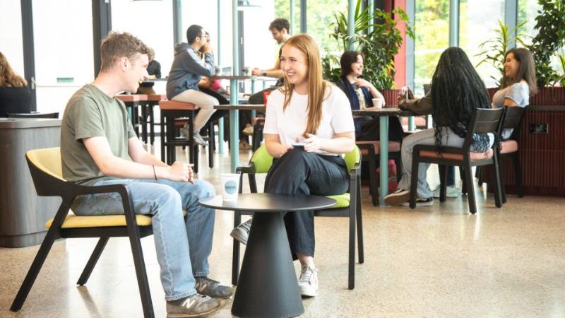 students chatting across a table